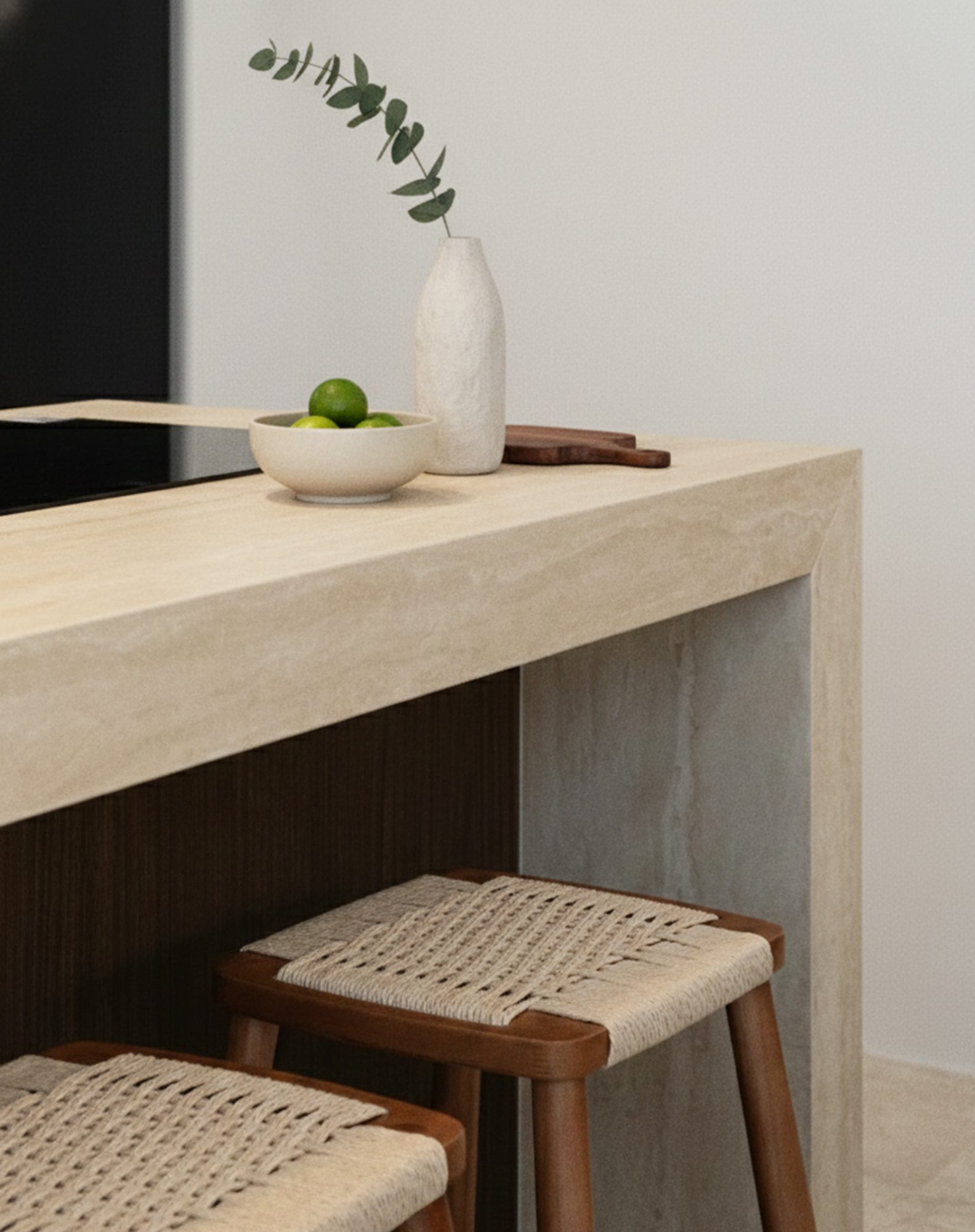 Travertine console with a shadow-gap edge, a ceramic vase and a woven-cord stool tucked beneath
